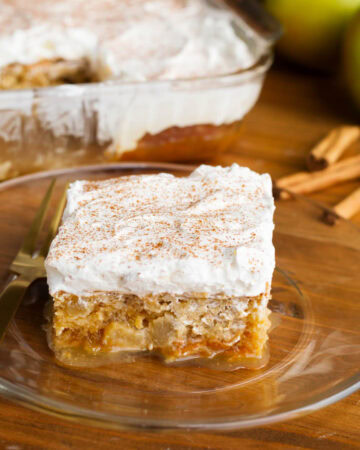 Caramel Apple Poke Cake slice on a glass plate